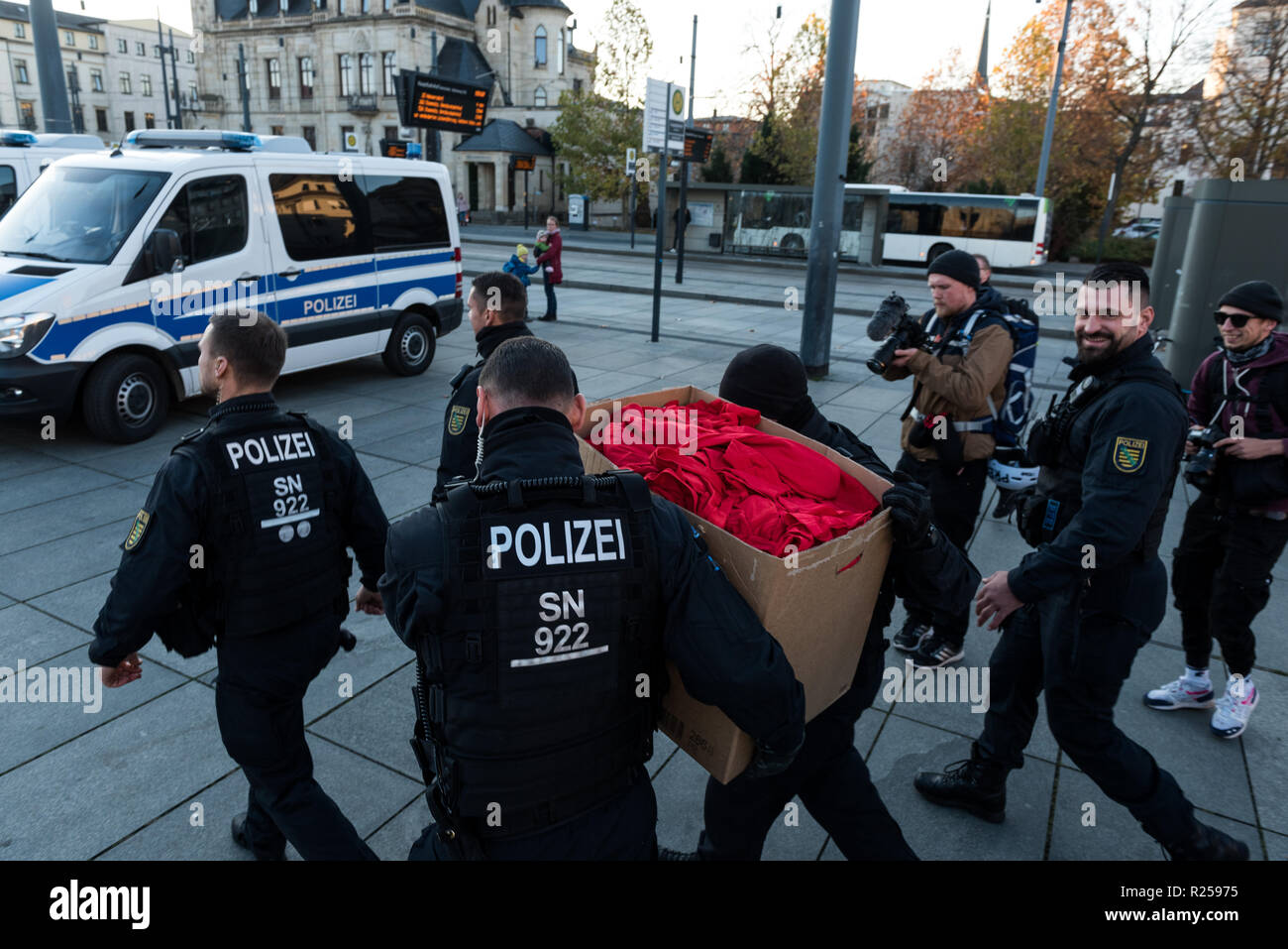 Policemen seen taking away confiscated T-shirts during the right-wing protest. Right-wing protests against Merkel's visit to Chemnitz, Deutschland. The Chancellor visited the city and talked to the citizens in a citizens' forum after protests and riots broke out in August after a violent death of a 35-year-old man from Chemnitz. Stock Photo