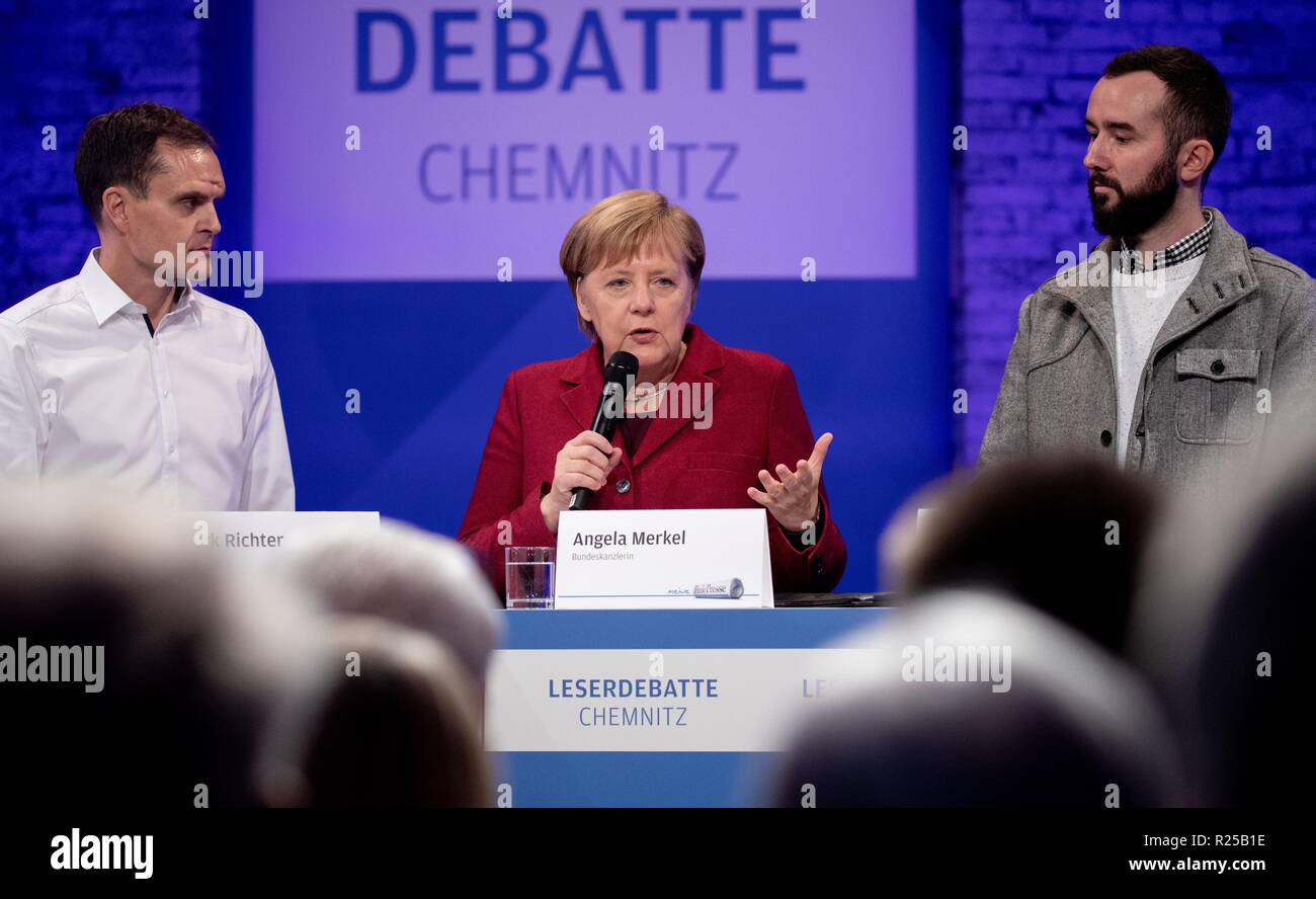 Chemnitz, Germany. 16th Nov, 2018. Chancellor Angela Merkel (CDU) talks to readers and guests of the Freie Presse Chemnitz Dirk Richter (l) and Thomas Höppner (r). The Chancellor's visit to Chemnitz was prompted by a deadly knife attack on a German about three months ago and subsequent demonstrations with xenophobic attacks. Credit: Kay Nietfeld/dpa-Pool/dpa/Alamy Live News Stock Photo