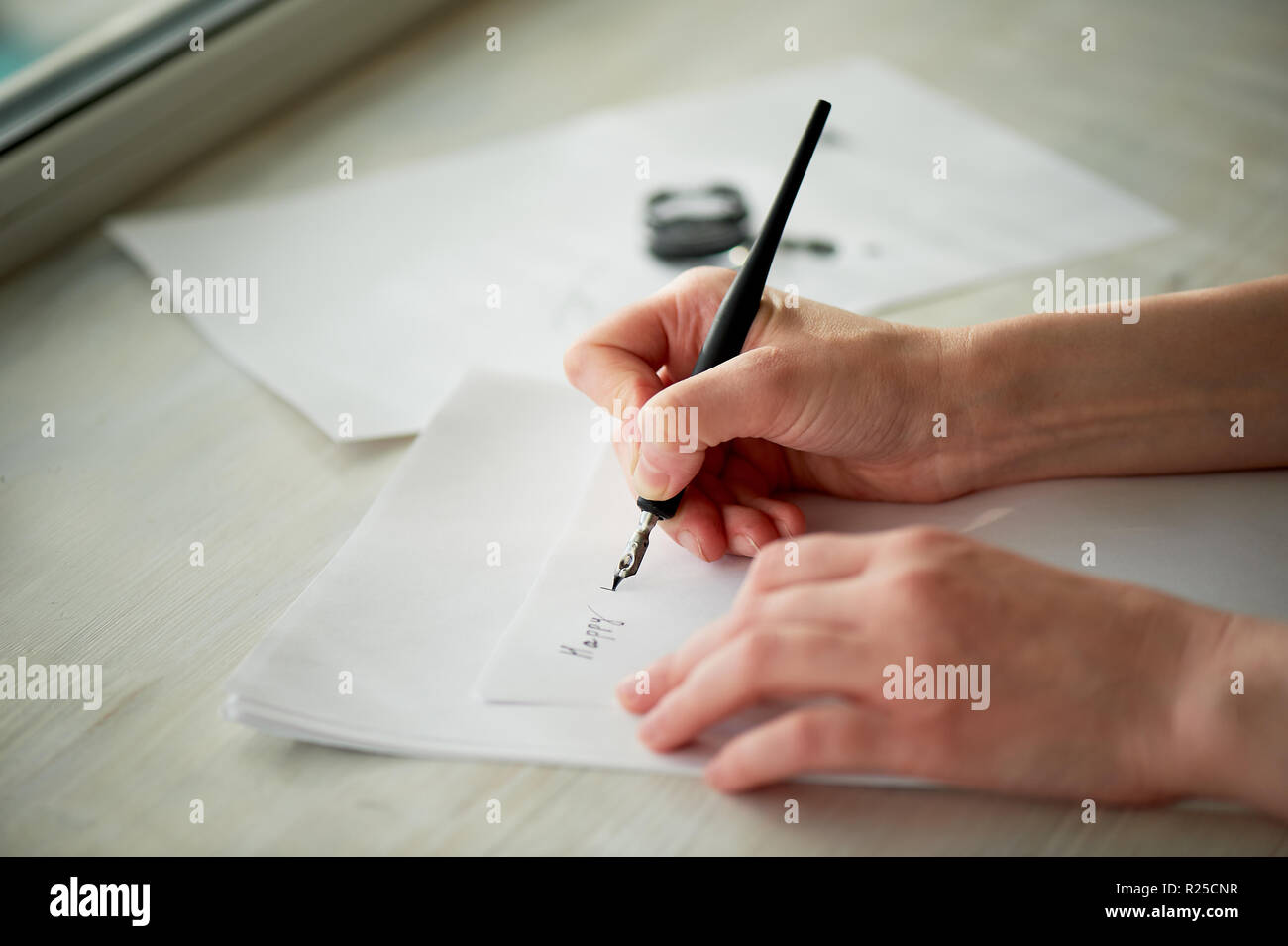 A woman's hand writes with ink, a fountain pen. Writing. The creative ...