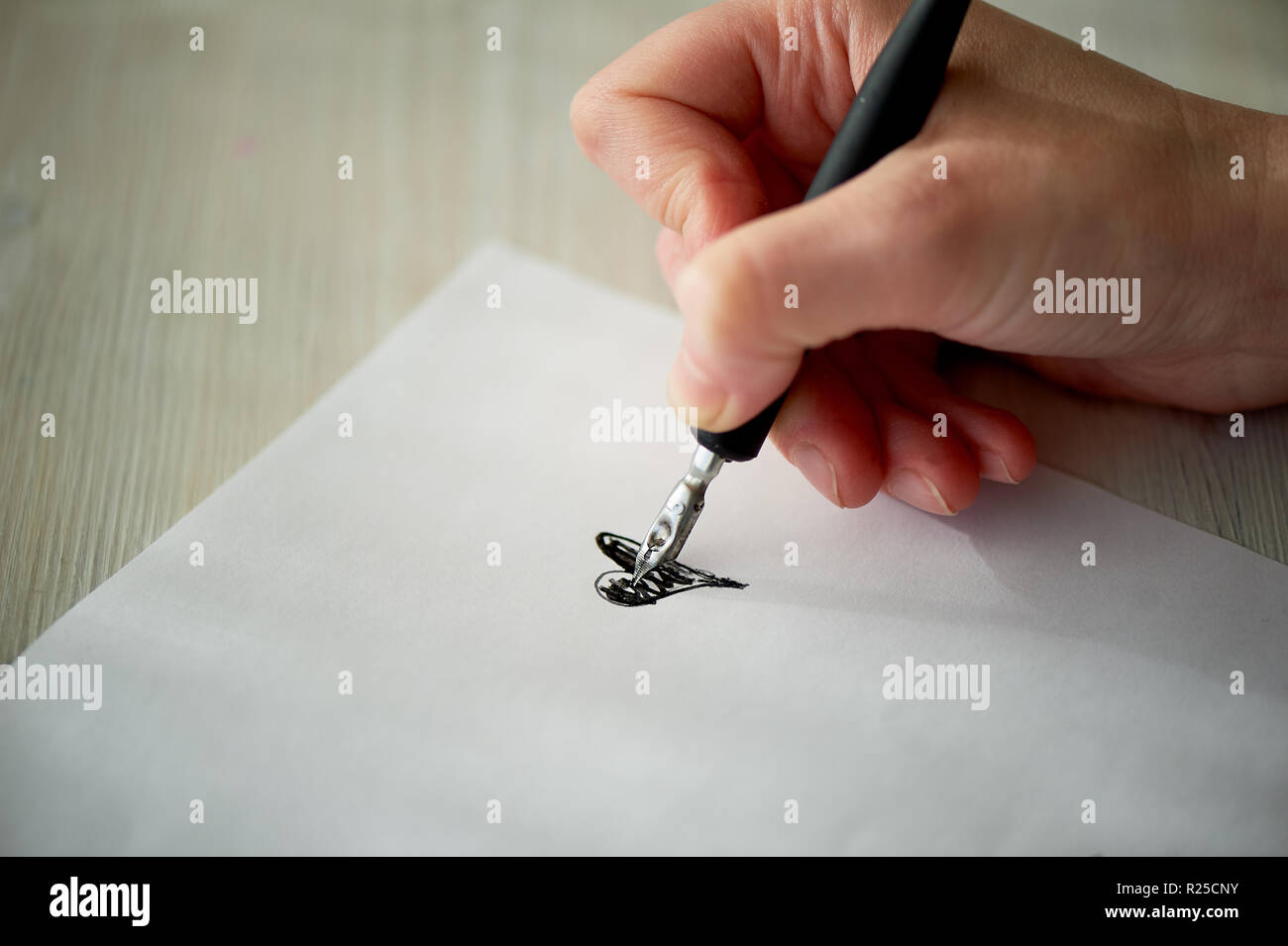 A woman's hand writes with ink, a fountain pen. Writing. The creative