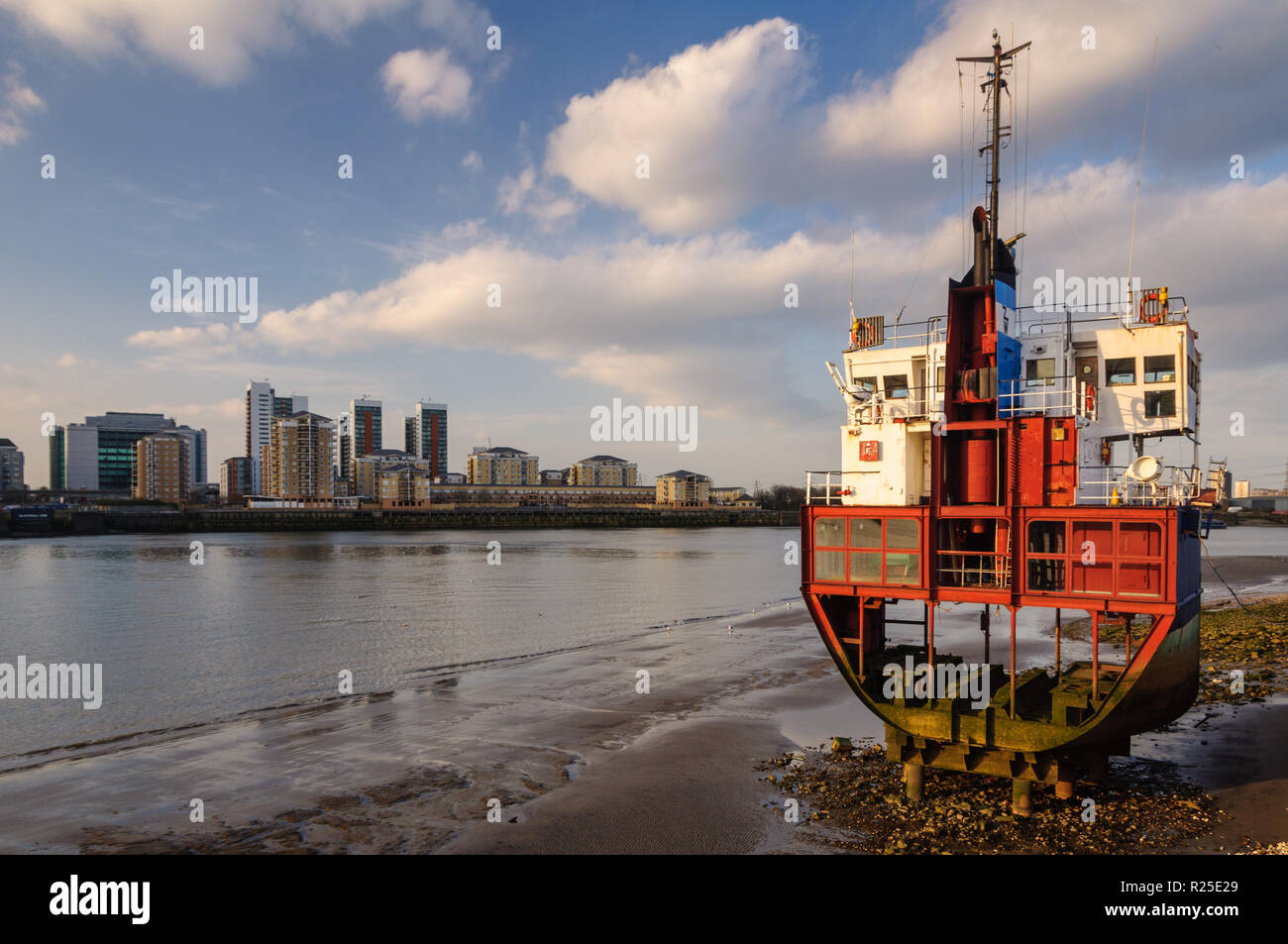 London, England, UK - March 22, 2009: A segment of a small cargo ship rests on the side of the River Thames at North Greenwich, an art installation by Stock Photo