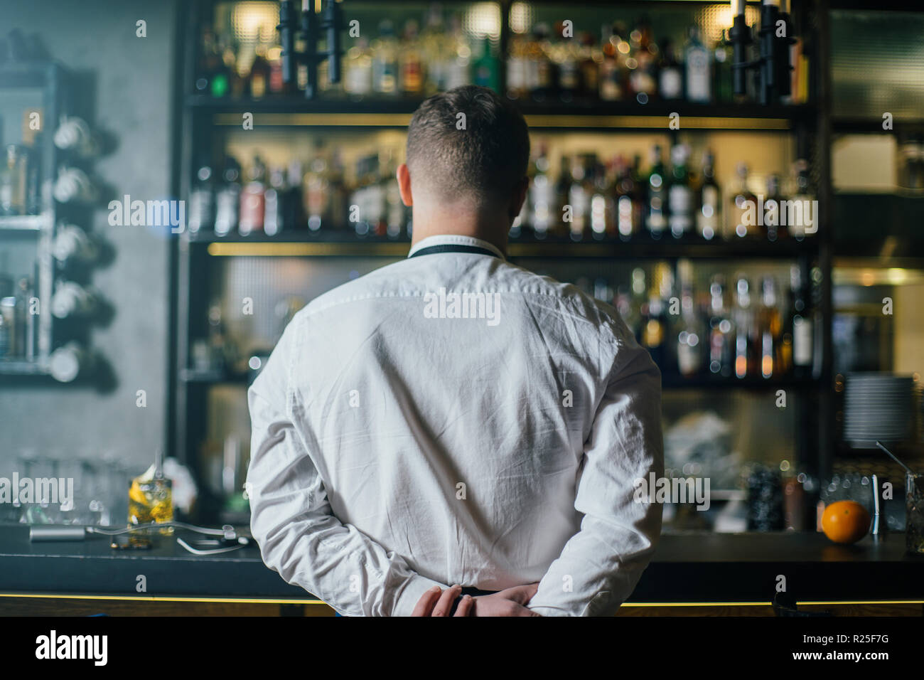 Bartender think before start to work. Photo with back Stock Photo Alamy
