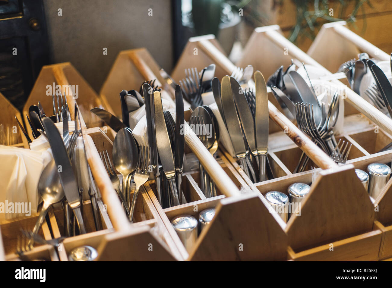 Forks, knifes and spoons in restaurants interior. Kitchenwear in close up, ready to service. Stock Photo