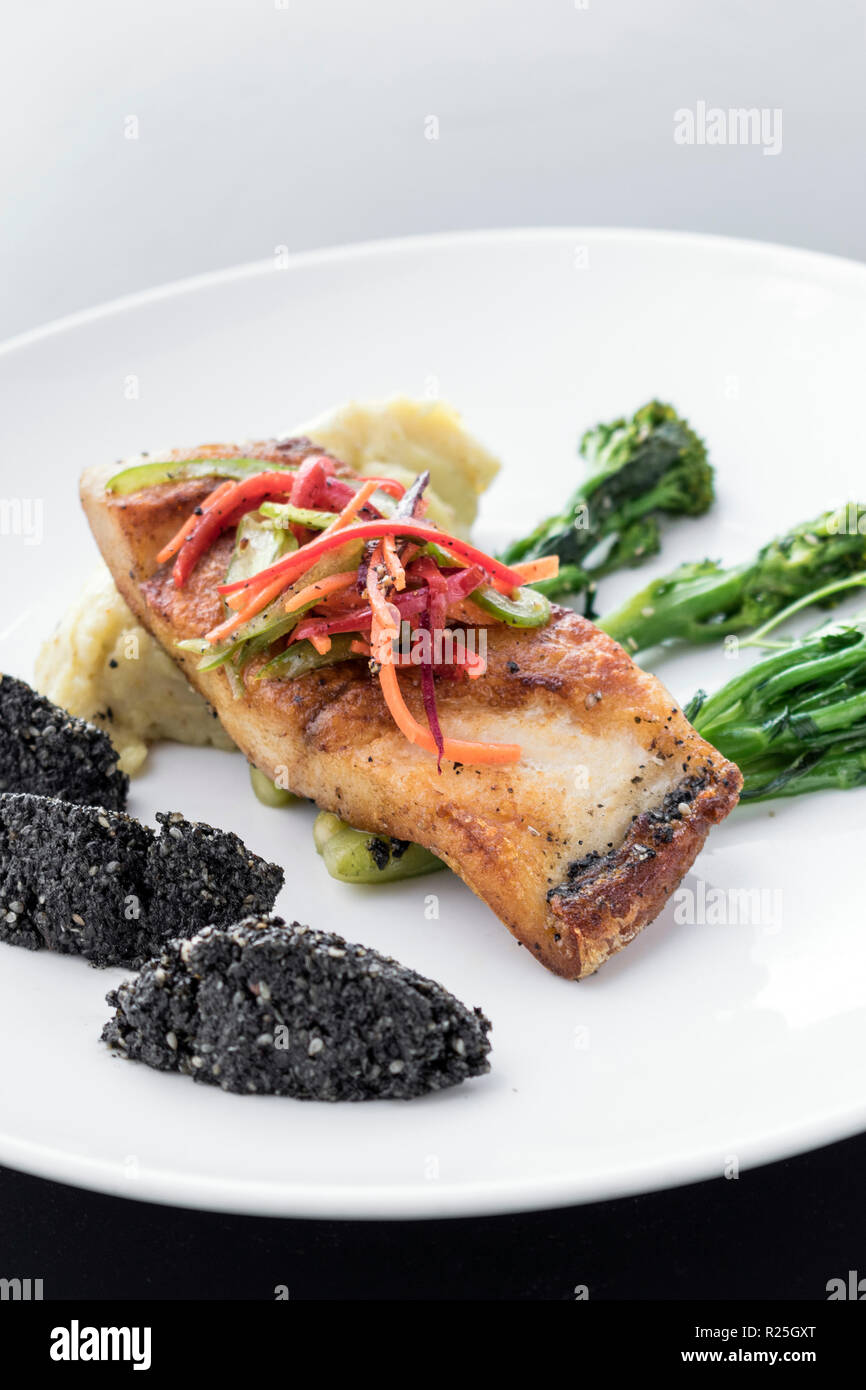 red snapper fish fillet with vegetables and black rice with black