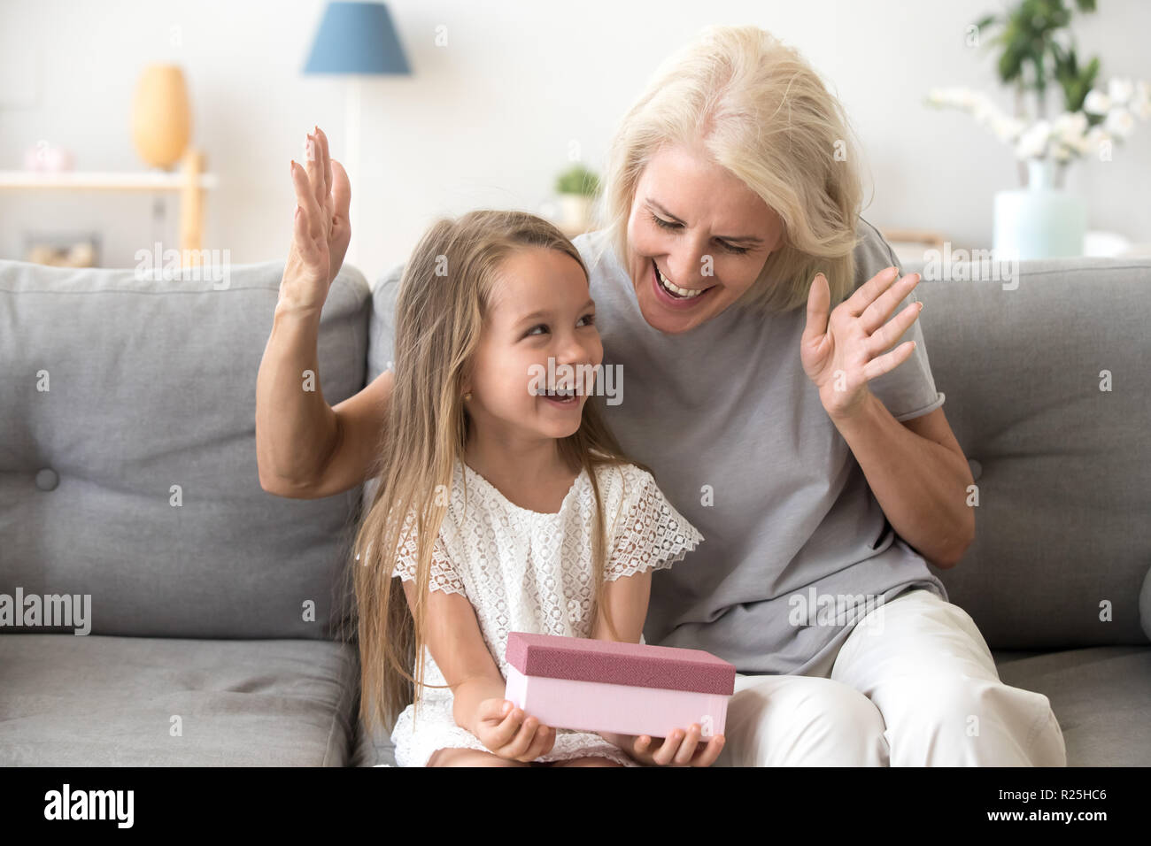 Excited grandchild happy to receive birthday present from loving Stock Photo