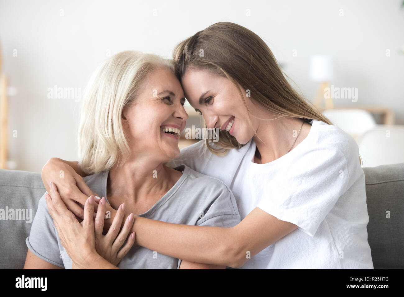 Happy loving older mother and grown millennial daughter laughing Stock Photo