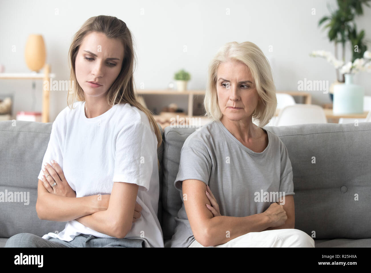 Upset older mother and adult daughter not talking after fight  Stock Photo