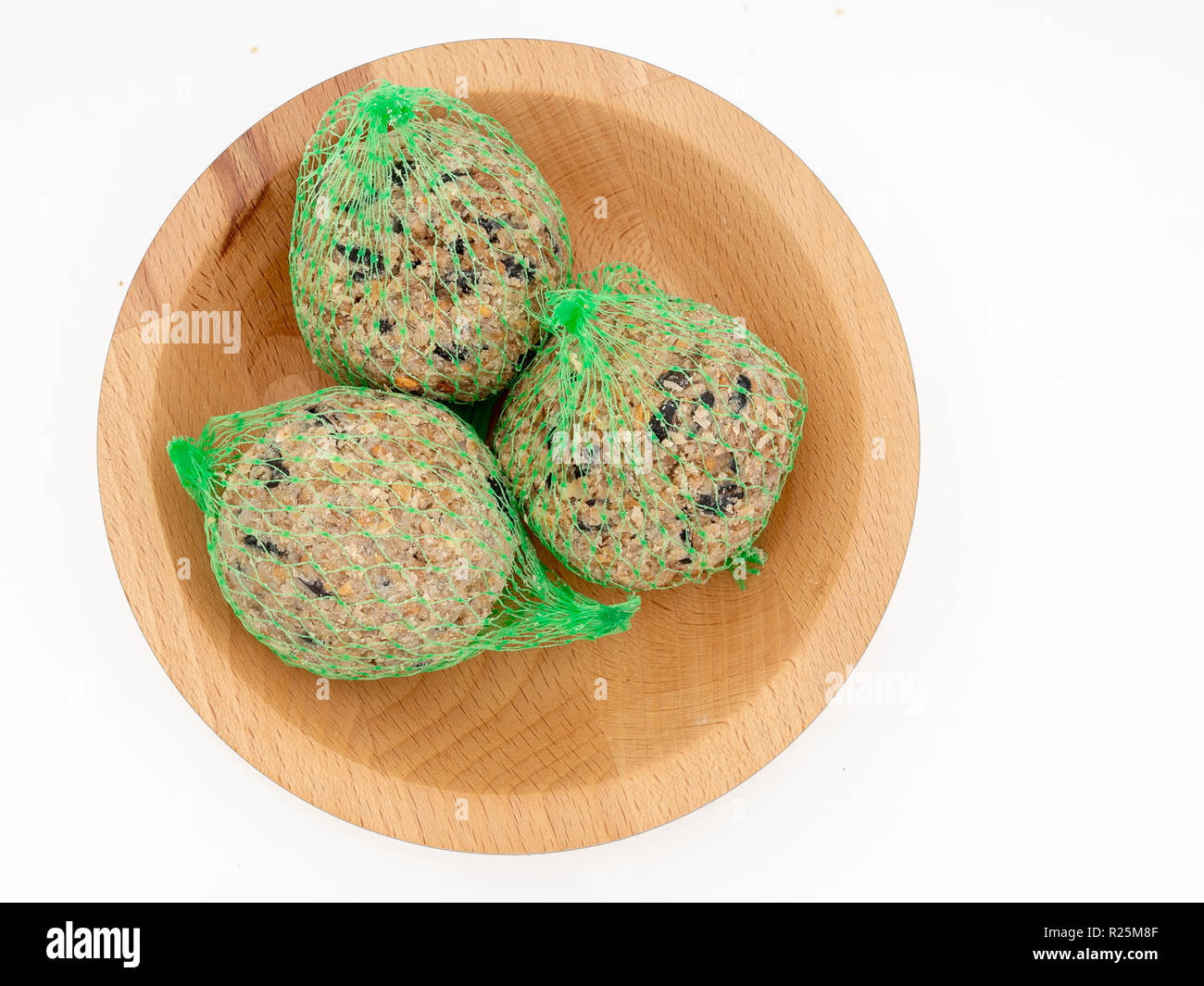 Fat balls for feeding wild garden birds, suet, in nets in bowl