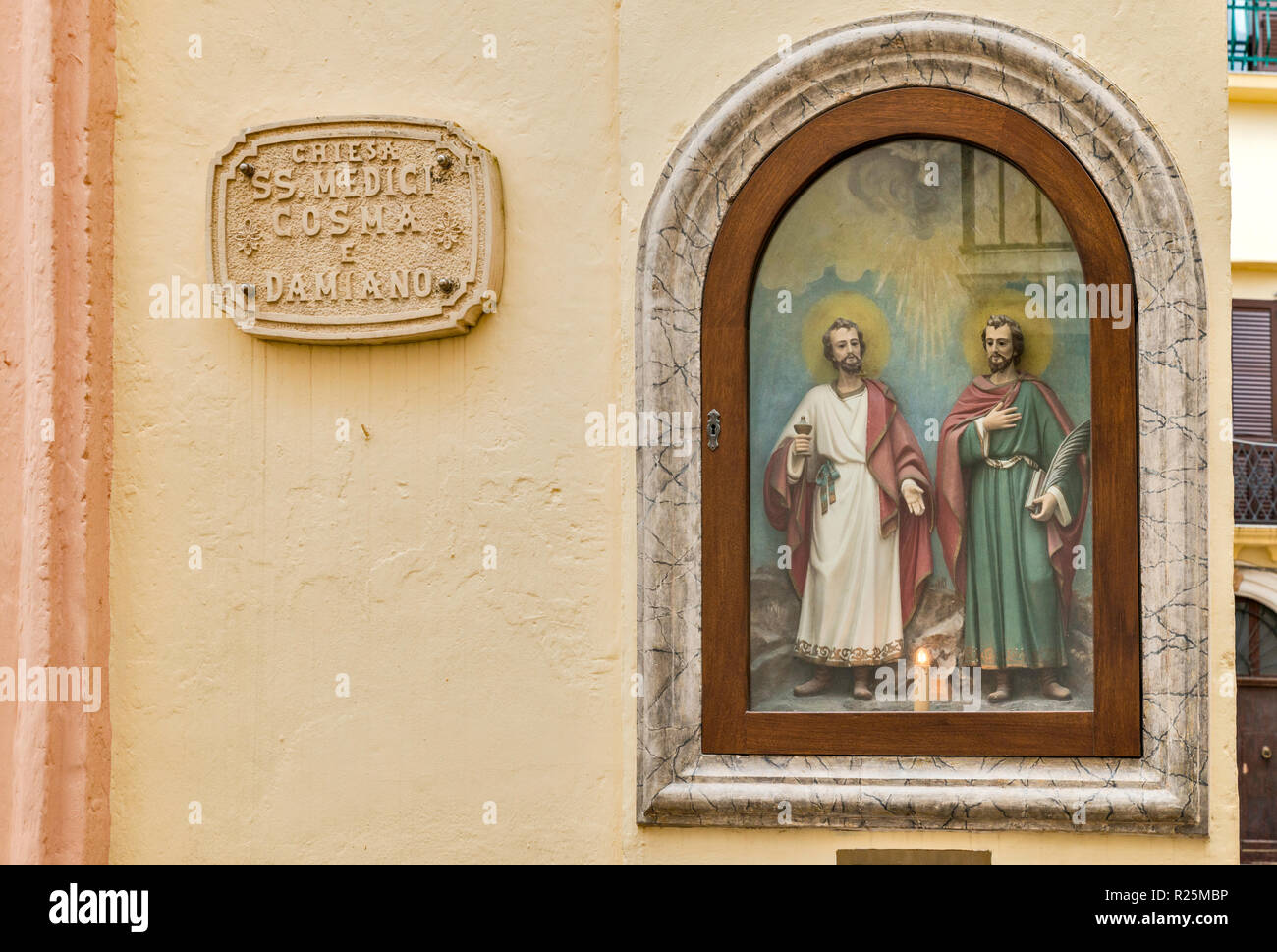 Saints Cosmas and Damian in painting on church, in historic center of Gallipoli, Apulia, Italy Stock Photo