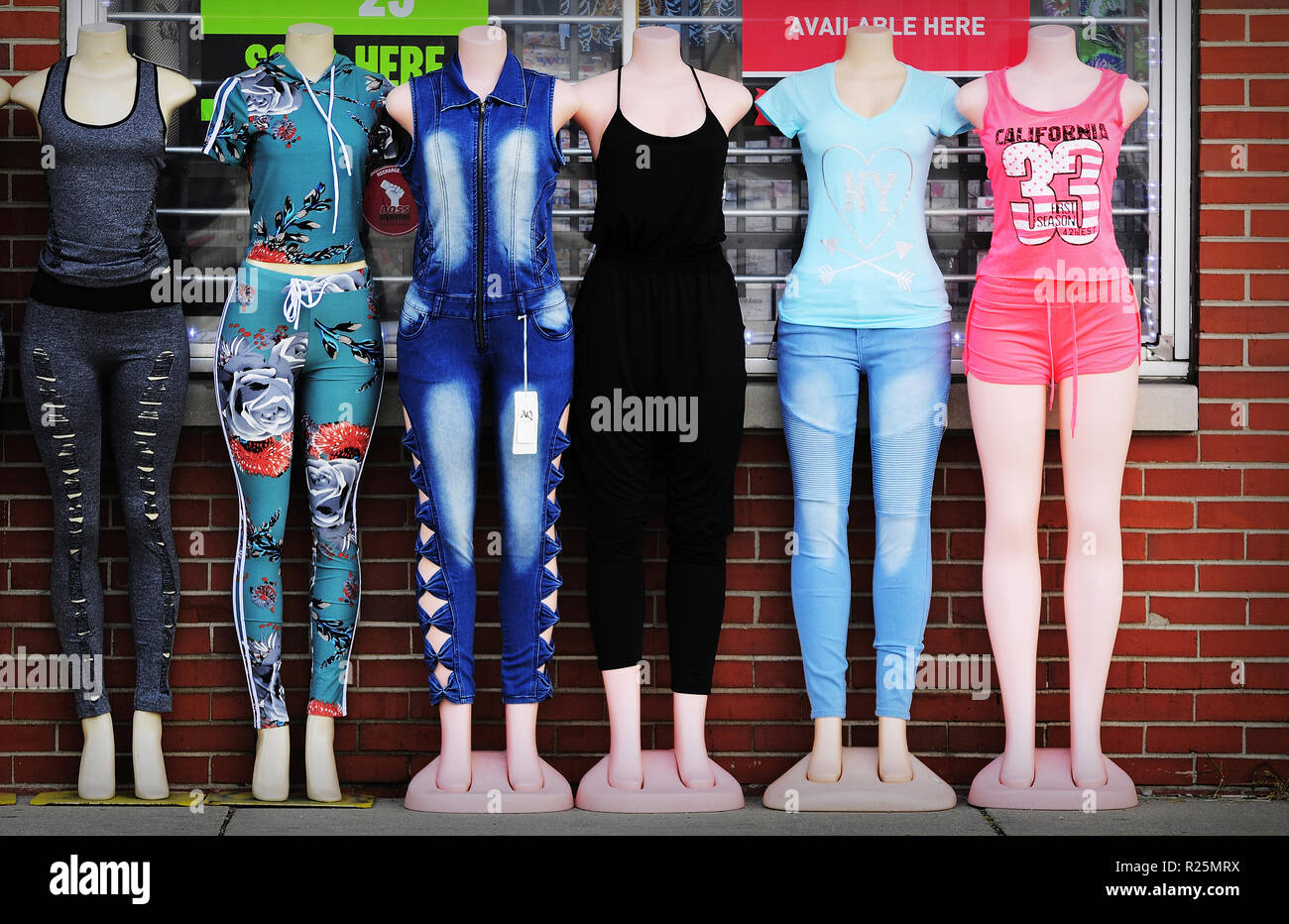 Clothing for young women on mannequins displayed outside a store. Stock Photo