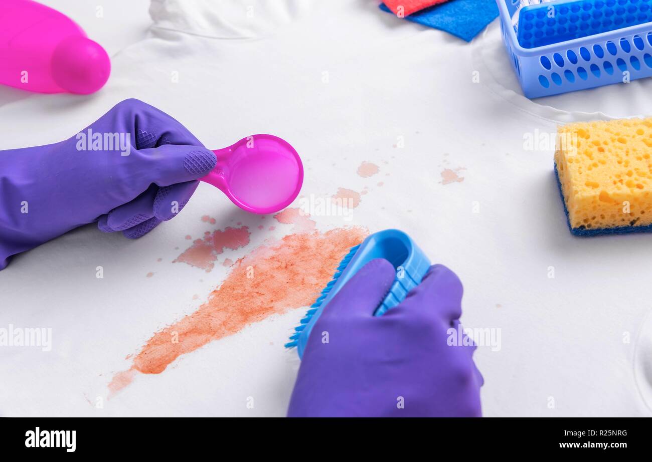 Female hands in gloves applied liquid stain remover Stock Photo Alamy