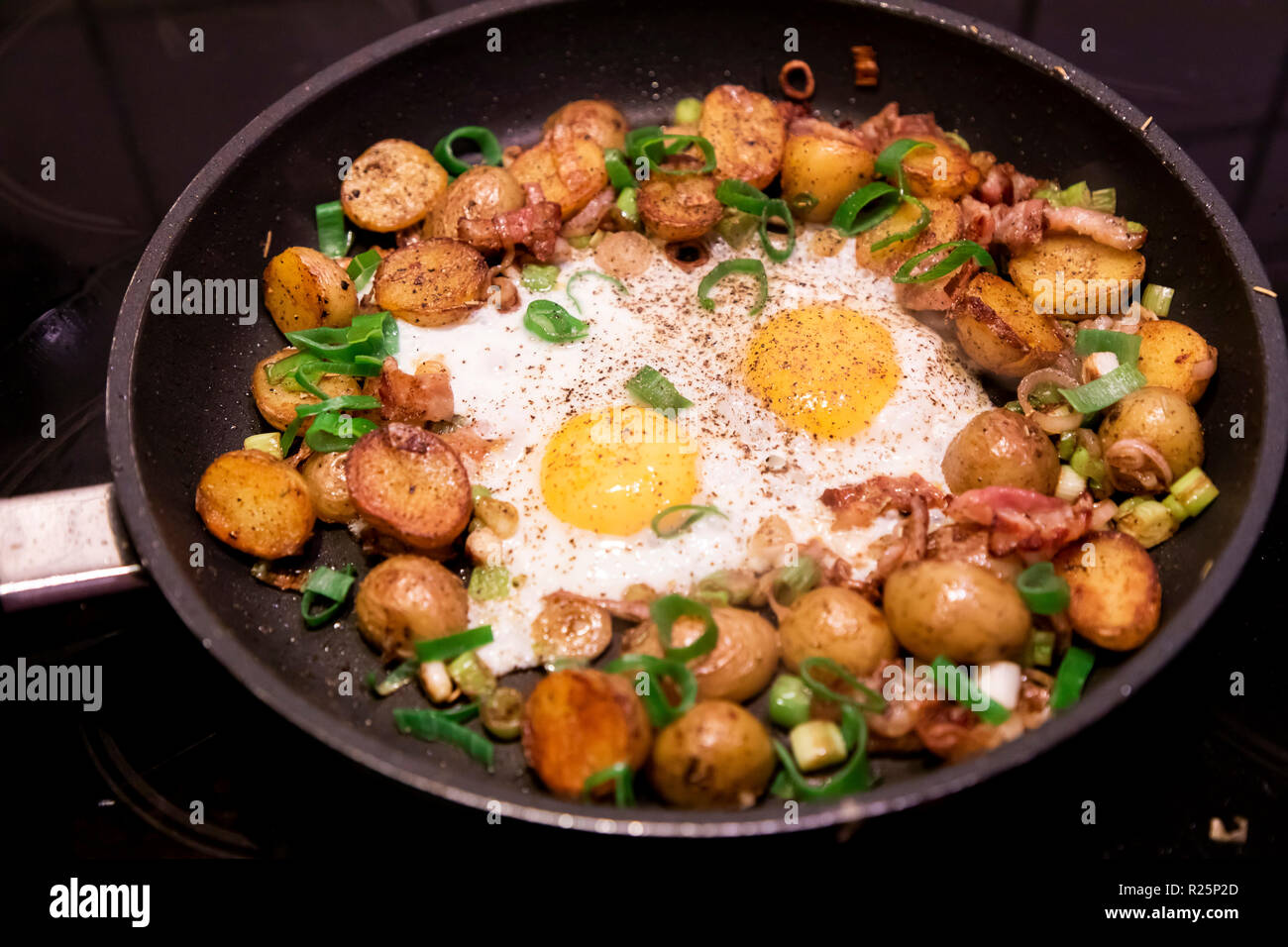 Pan with fried potatoes and fried eggs, potatoes with potatoes, with