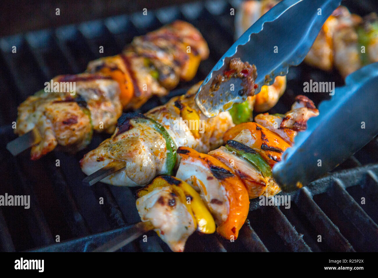 Meat and vegetables skewers on a grill, poultry meat and pepper pieces on a skewer, are grilled, Stock Photo