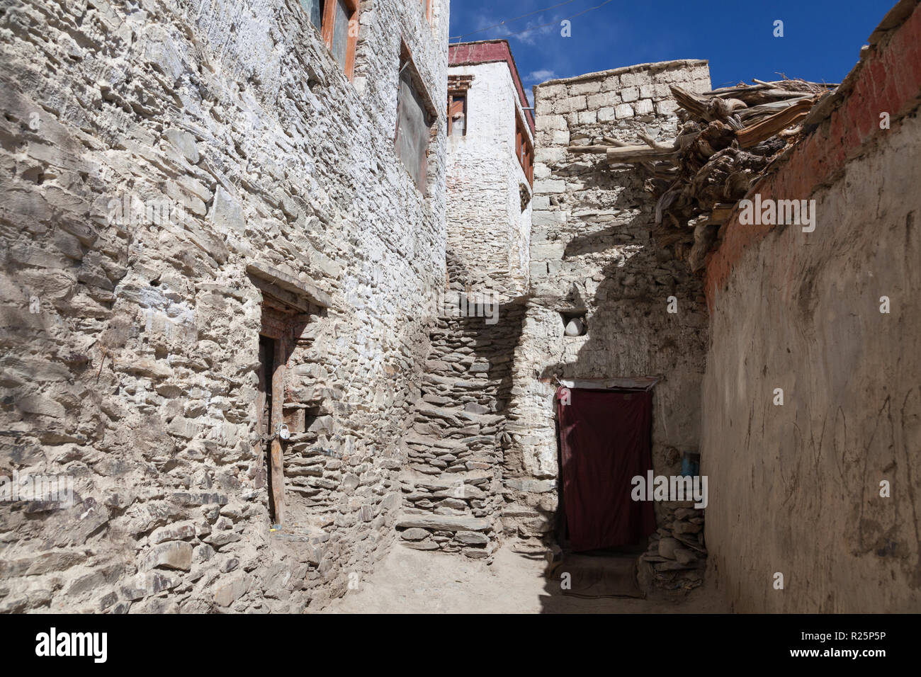 Buildings, stairs and pile of wood in Karsha Monastery, Zanskar, Jammu and Kashmir, India Stock Photo