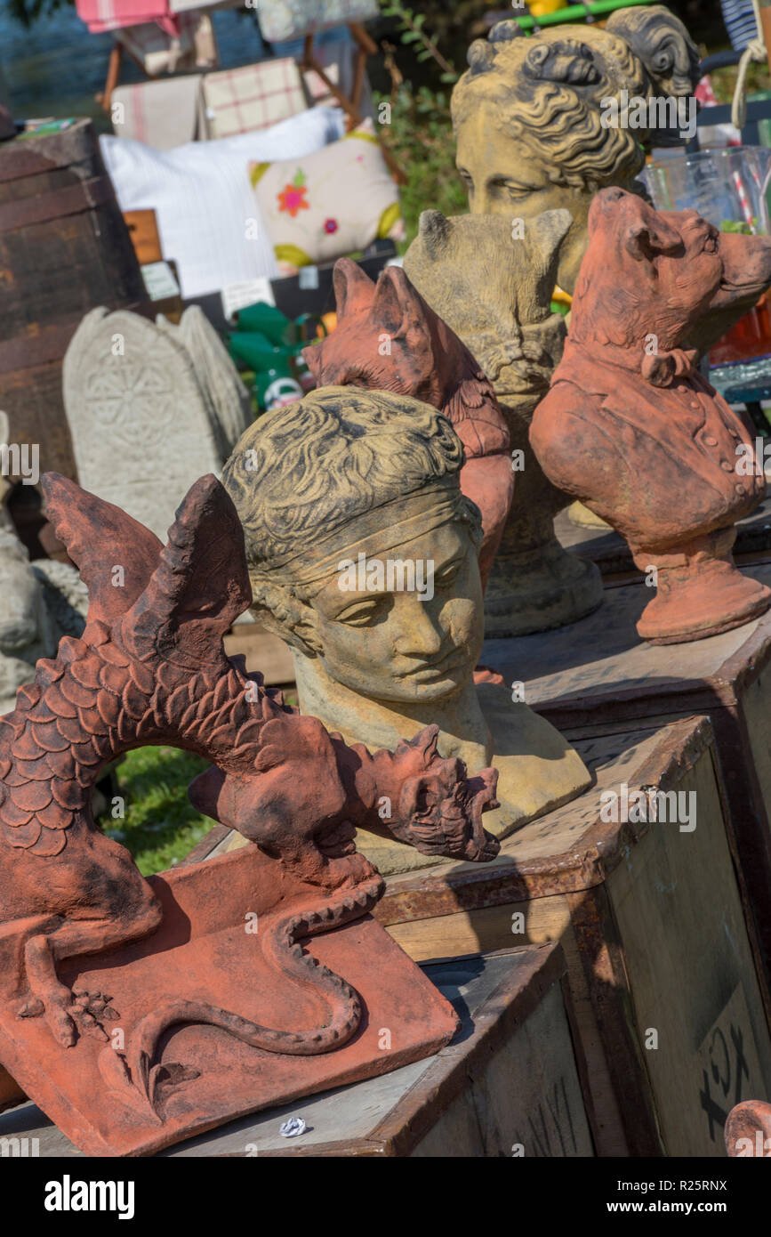 collection of antiques and stone garden statuary for sale at a garden