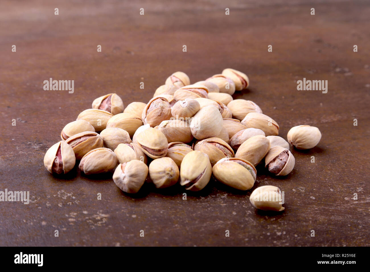 Salt pistachios on a stone table. Close-up Stock Photo