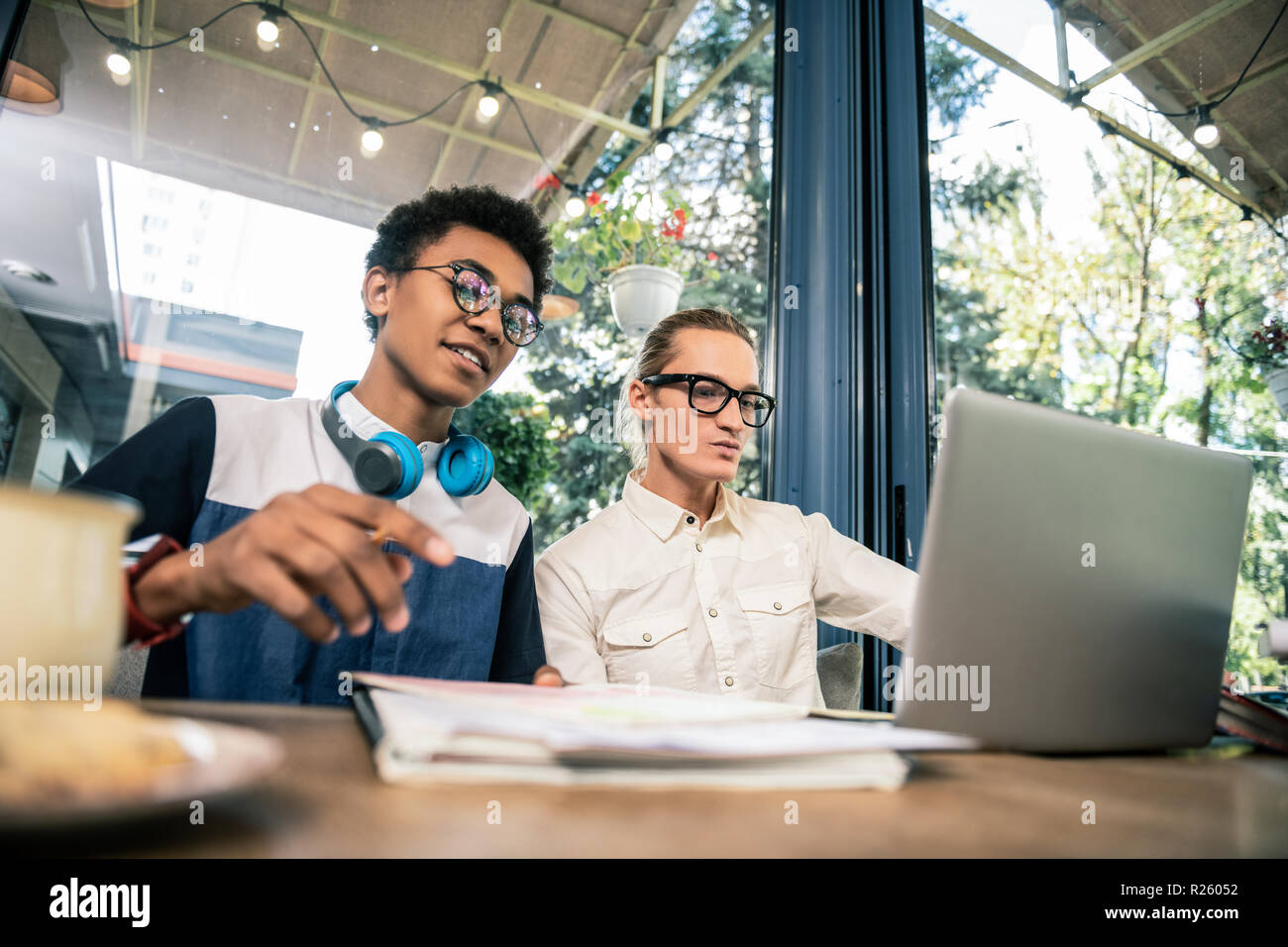 Nice young students sitting at the table Stock Photo