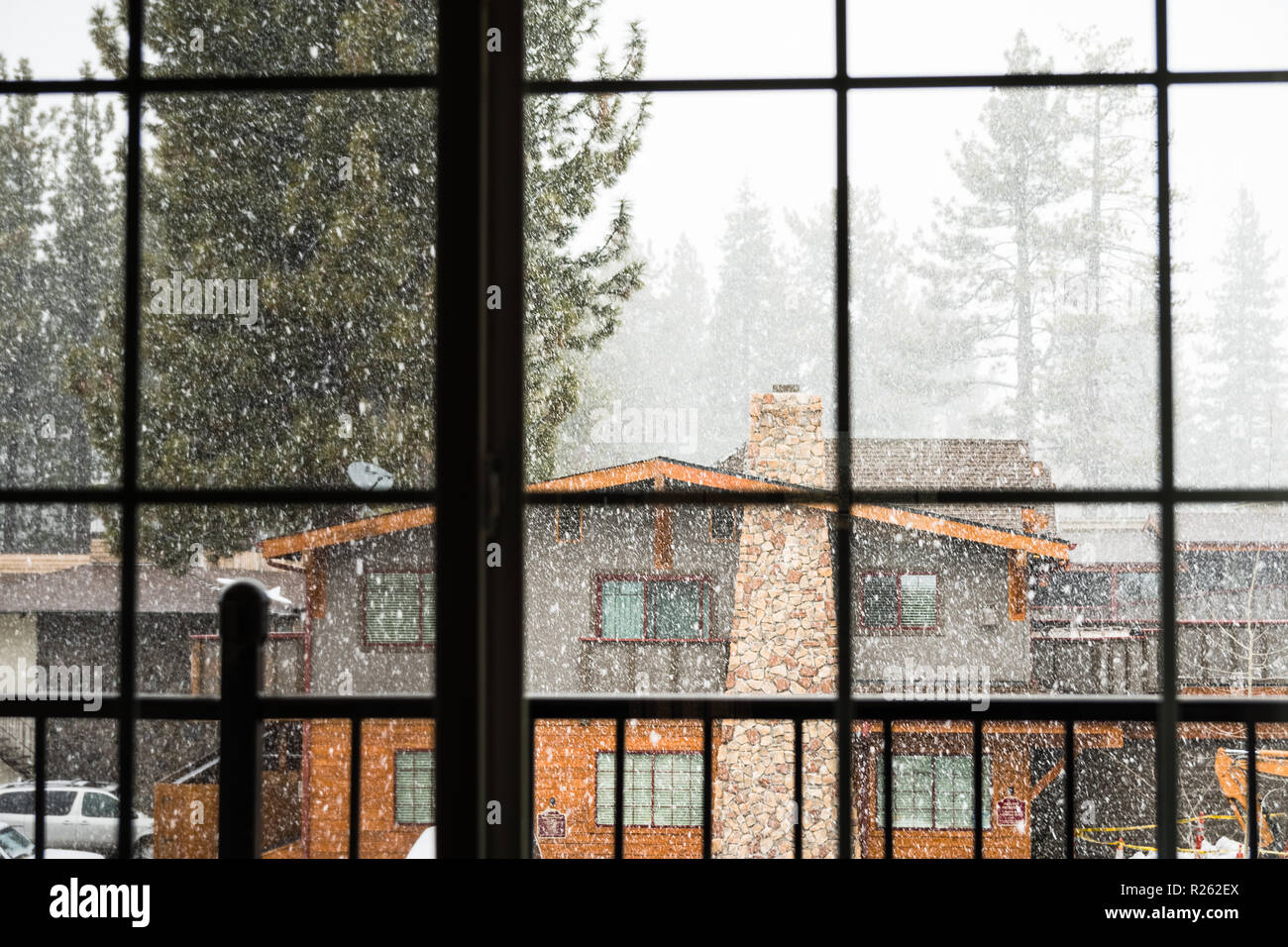 Looking outside through a window at falling snow, South Lake Tahoe, California Stock Photo