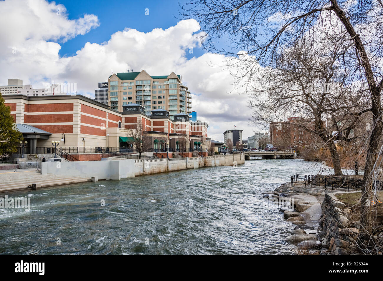 Reno, Nevada skyline as seen from the shoreline of Truckee river flowing through downtown; Stock Photo