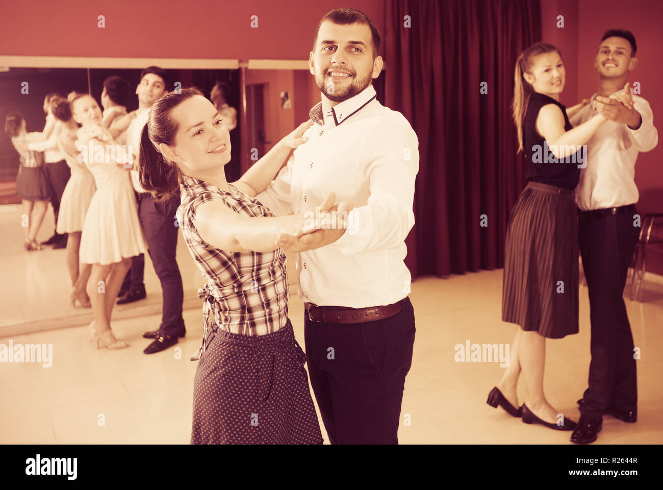 Young people dancing together slow ballroom dances in pairs Stock Photo
