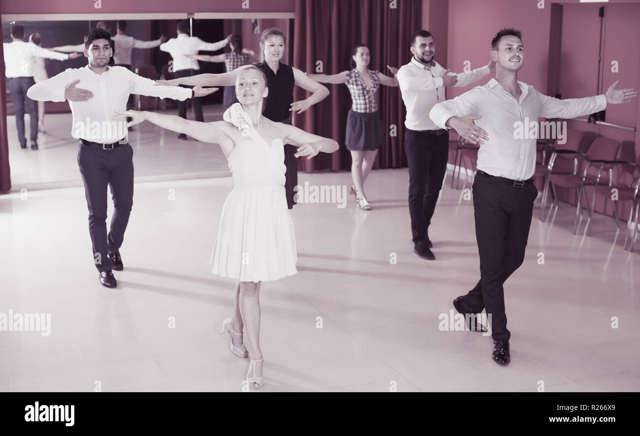 Young people practicing passionate samba in dance class Stock Photo