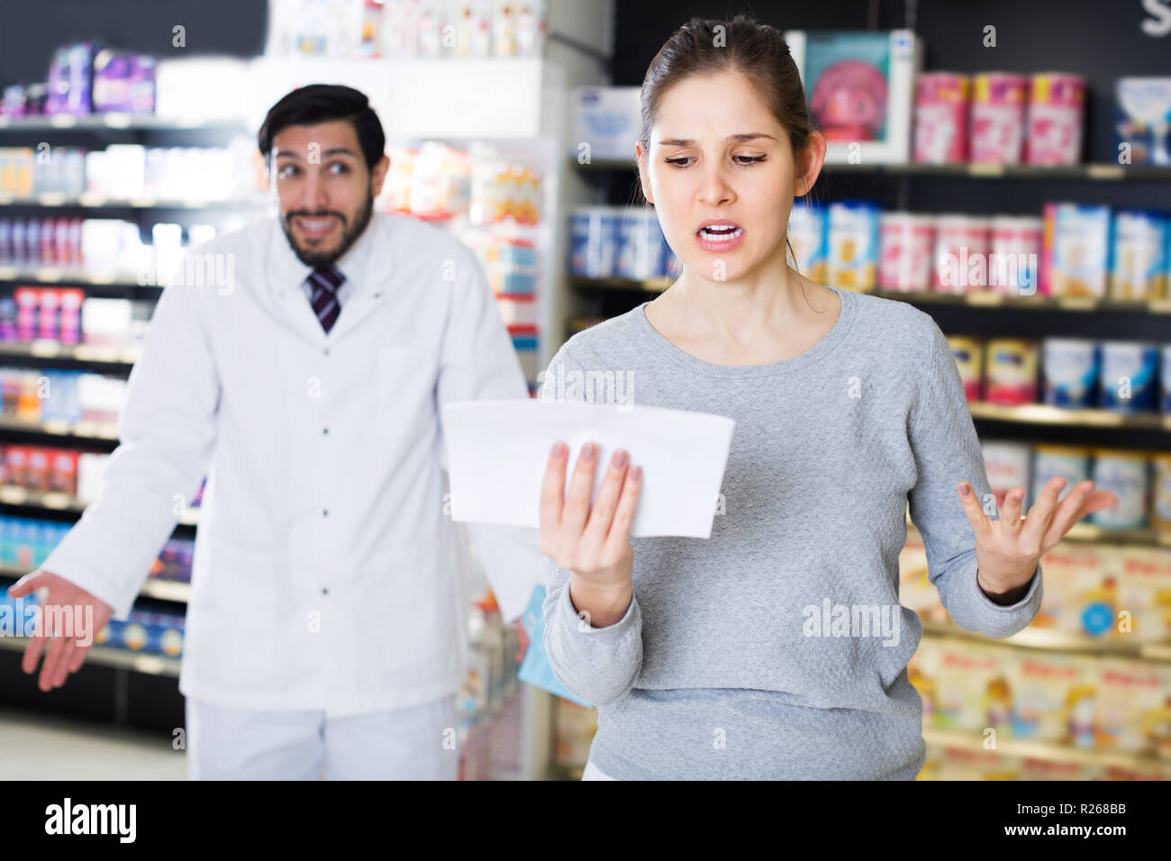 Portrait of outraged woman customer with medicines in drugstore Stock ...