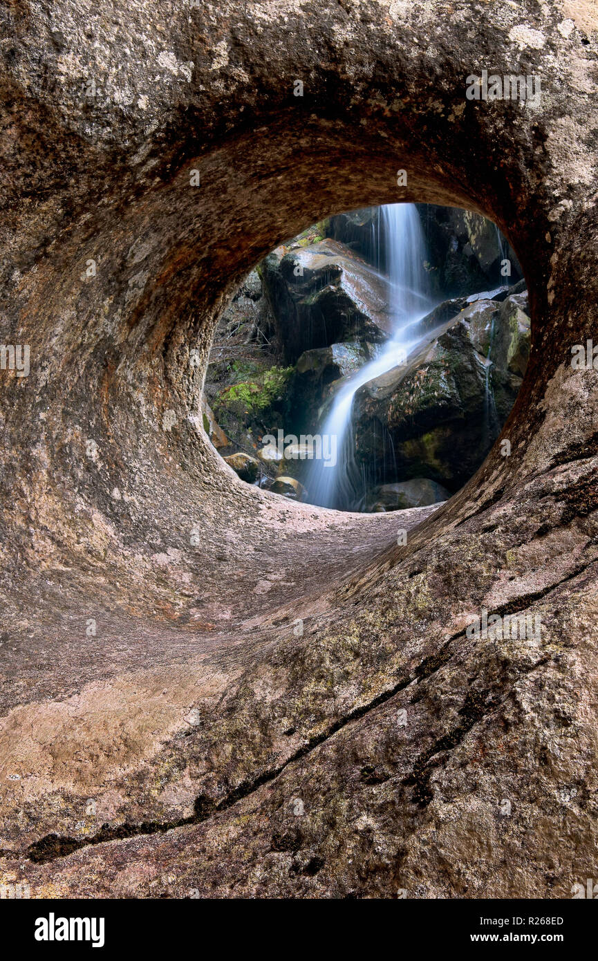 Waterfall through hole in boulder, White Mountains National Forest, New Hampshire, USA Stock Photo