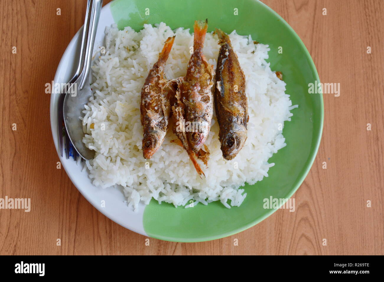 fried fish topping on plain rice Stock Photo - Alamy