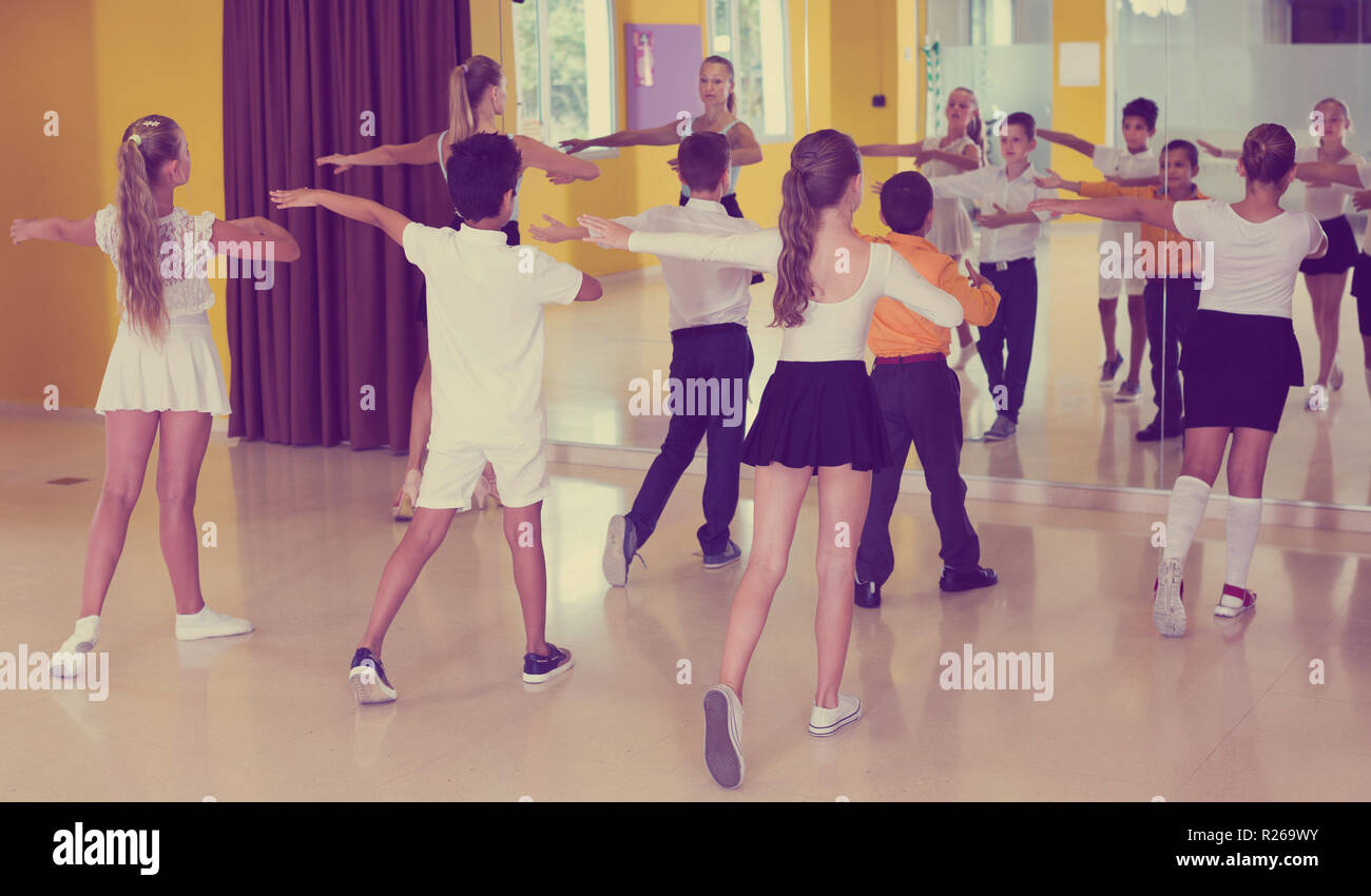 Positive children learn dance movements in dance class Stock Photo - Alamy