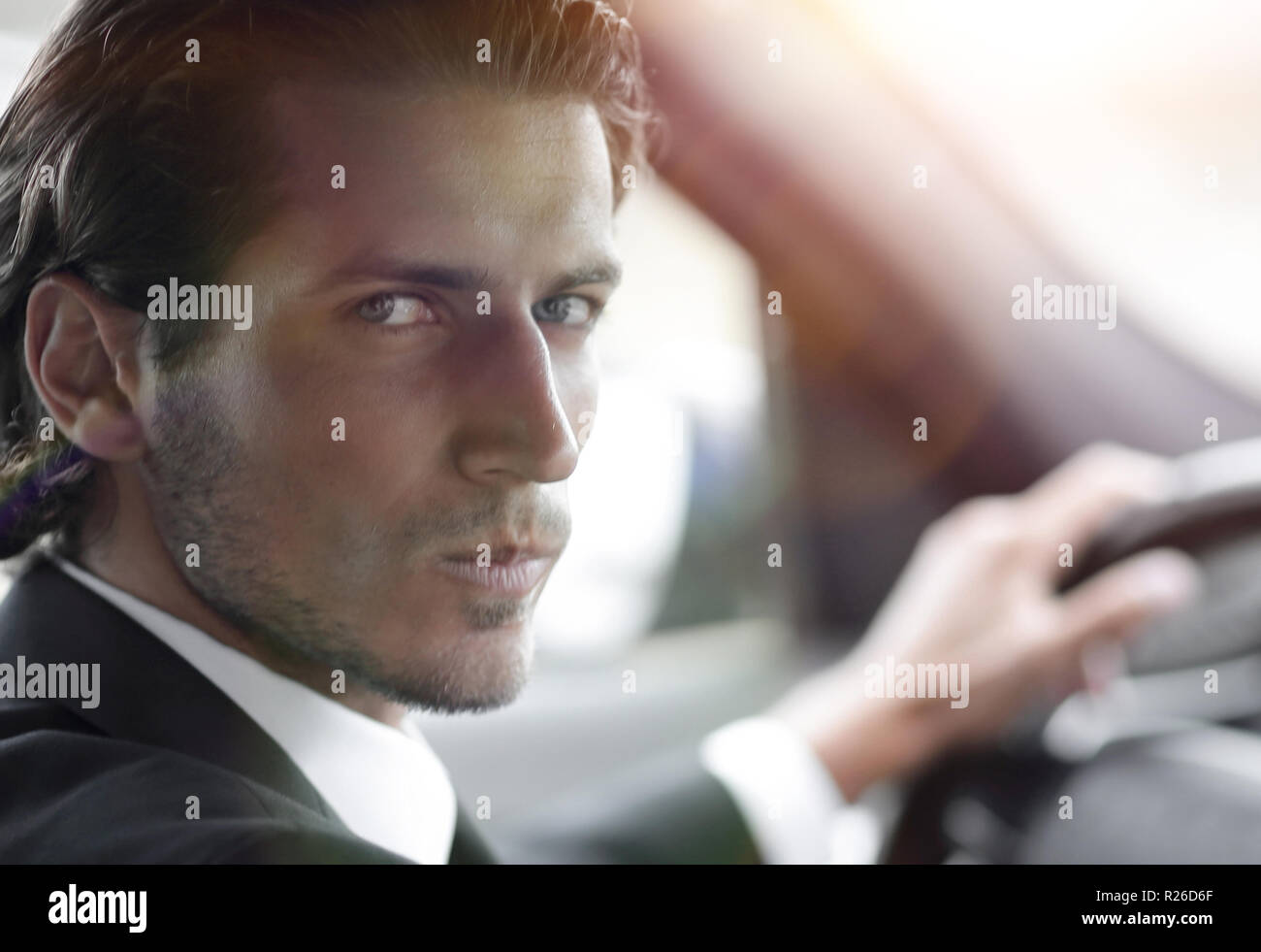 man sitting behind the wheel of a car Stock Photo - Alamy