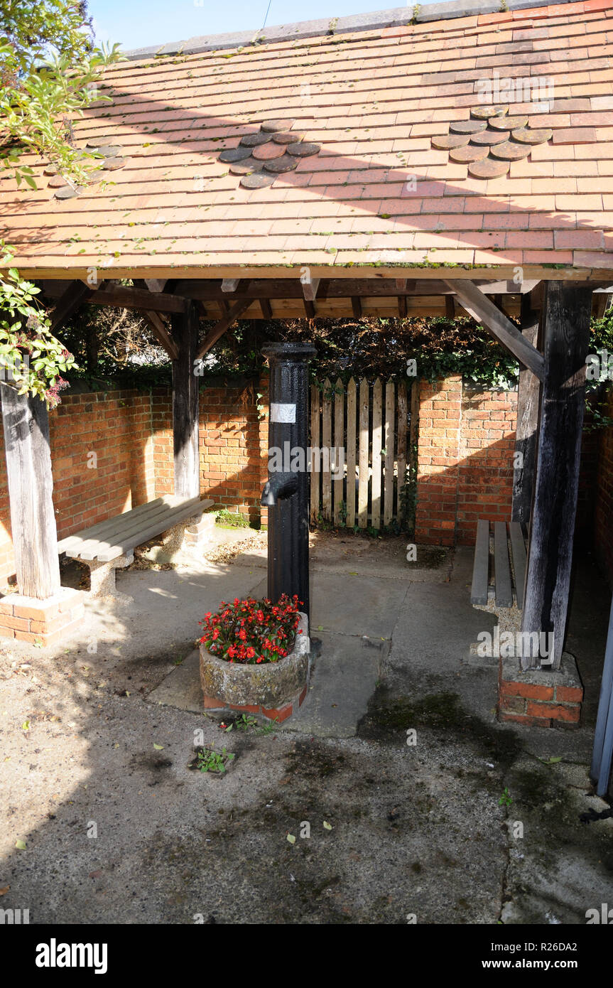 The Village Pump housed in a shelter, Steeple Claydon, Buckinghamshire. Stock Photo