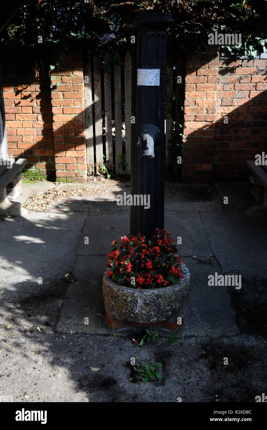 The Village Pump housed in a shelter, Steeple Claydon, Buckinghamshire. Stock Photo