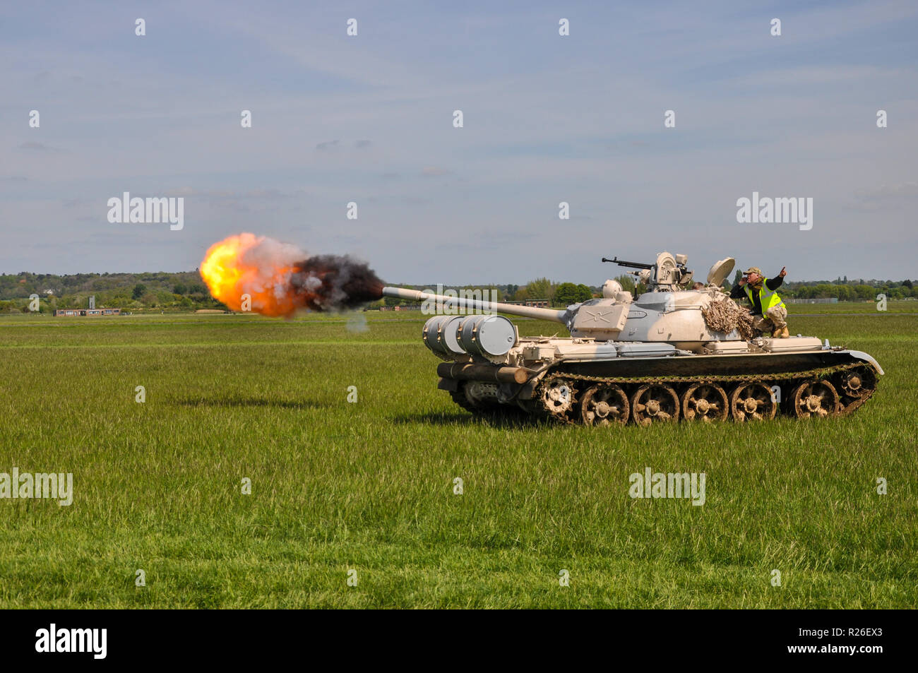 The T-54 and T-55 tanks are a series of main battle tank introduced just as the Second World War ended. T55 seen firing gun. Space for copy Stock Photo