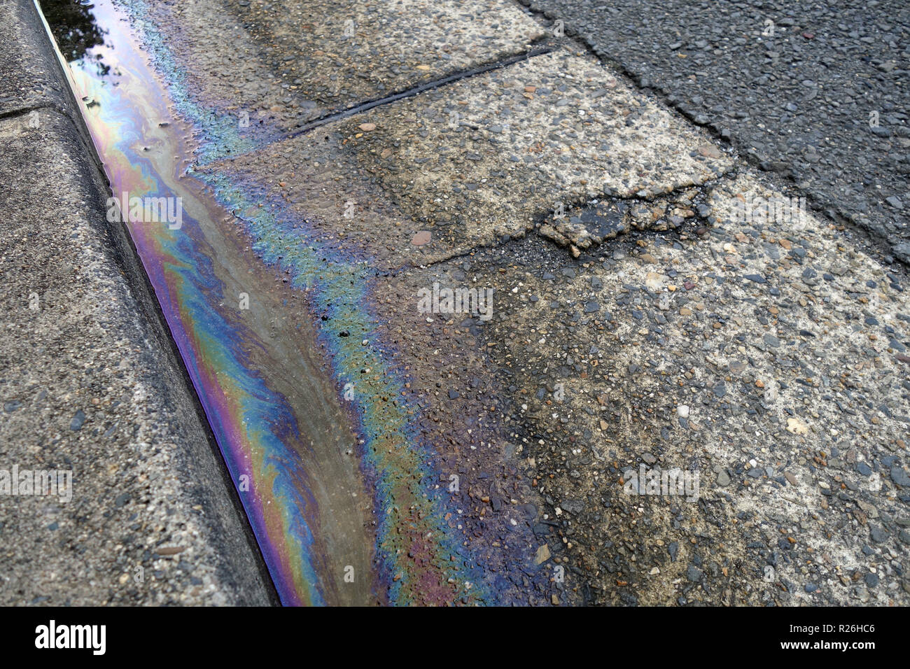 Petrochemical pollution in street gutter Stock Photo