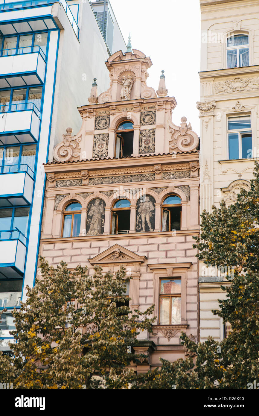 Exterior of a traditional old building among modern houses in Prague in the Czech Republic. Preservation of traditional medieval architecture in modern Prague. Stock Photo