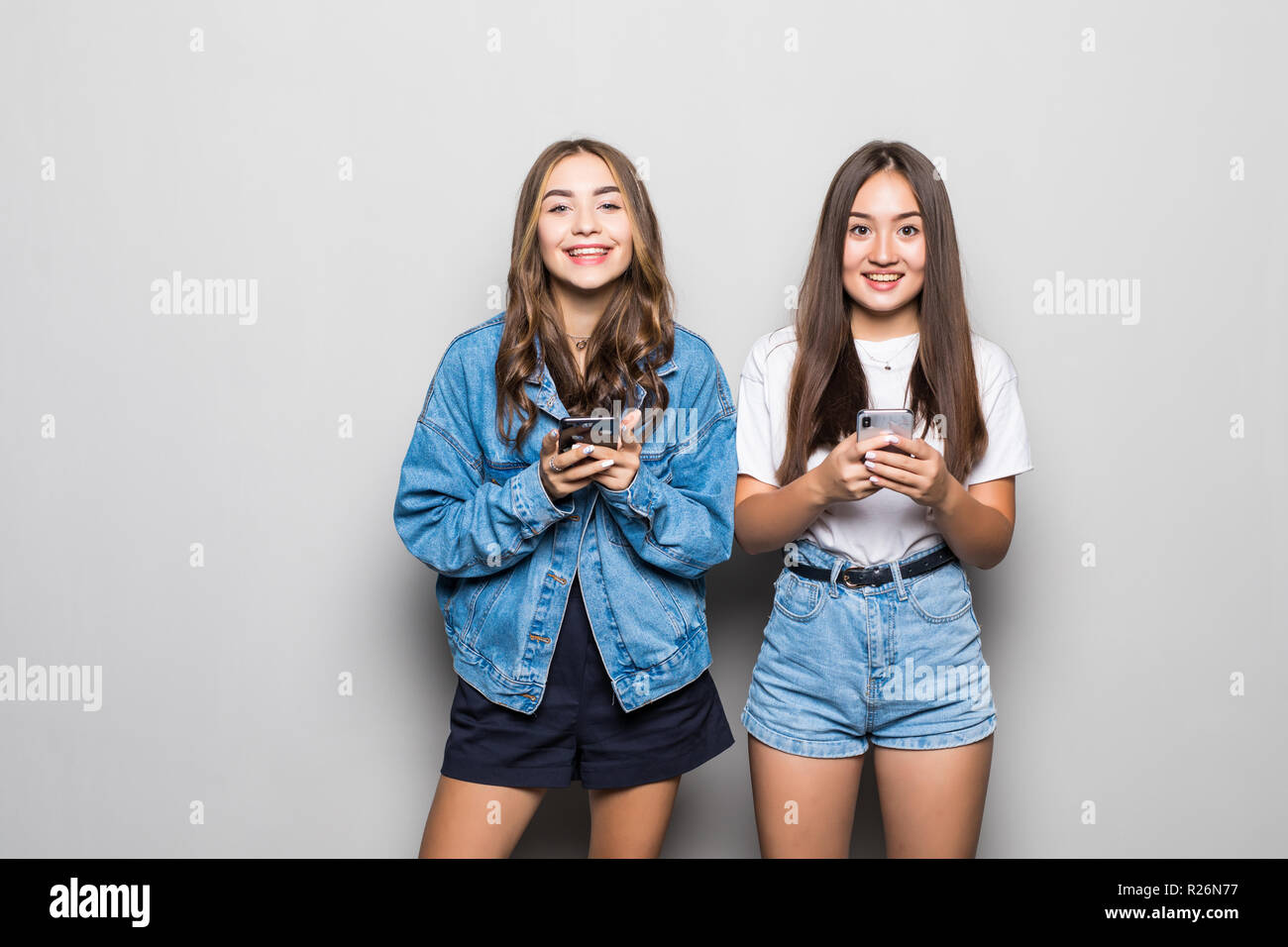 Two multiethnic summer women wearing straw hats expressing excitement ...
