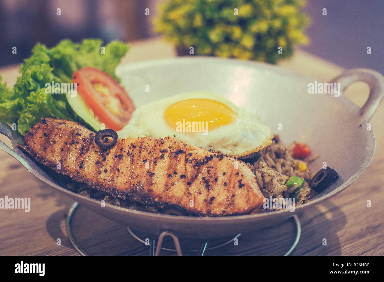Black Olive Fried Rice with Grilled Salmon fried egg and mixed vegetable Stock Photo