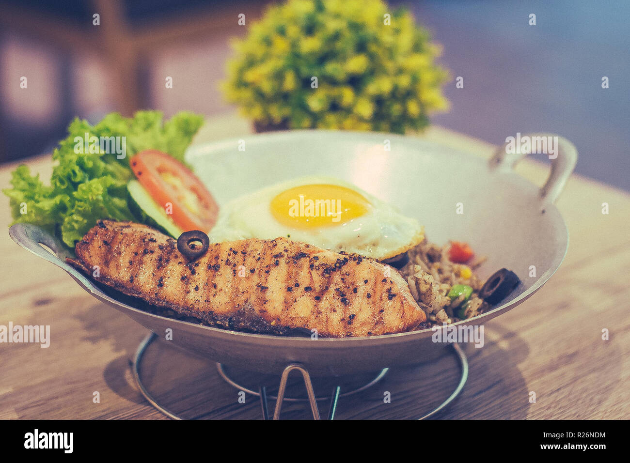 Black Olive Fried Rice with Grilled Salmon fried egg and mixed vegetable Stock Photo