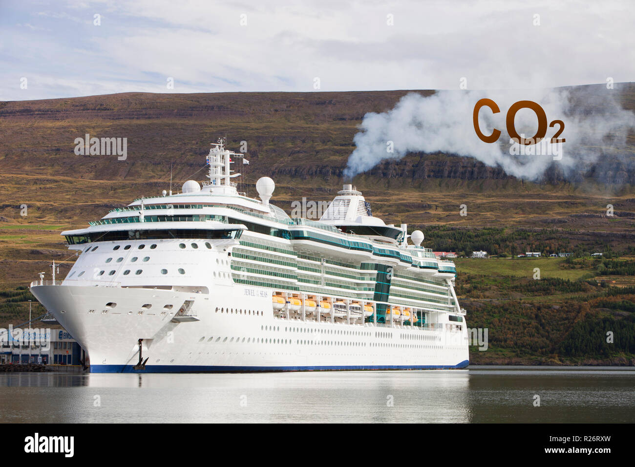 A massive cruise liner, The Jewel of the Seas, docked in Akureyri, and pouring out exhaust fumes Stock Photo