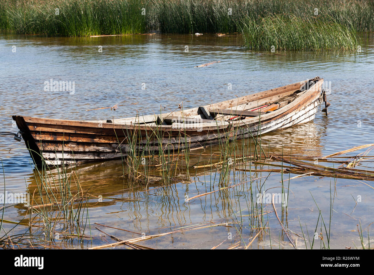 old wooden boat near the lake, used by local people for fishing