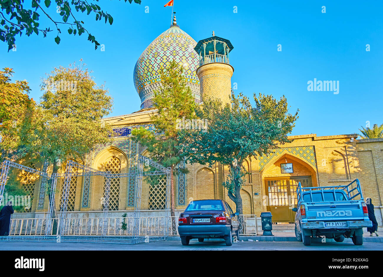 SHIRAZ, IRAN - OCTOBER 13, 2017: Exterior of scenic Imamzadeh Ali Ibn Hamzeh Holy Shrine, topped with masterpiece bulbous dome, covered with geometric Stock Photo