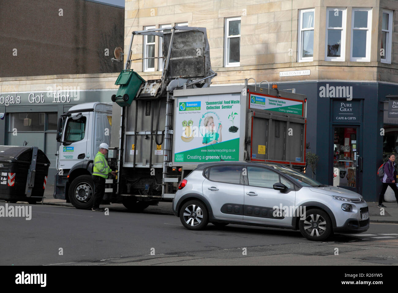 A green bin which has just emptied its contents into a bin lorry owned by Keenan Commercial Food Waste Collection Service Stock Photo