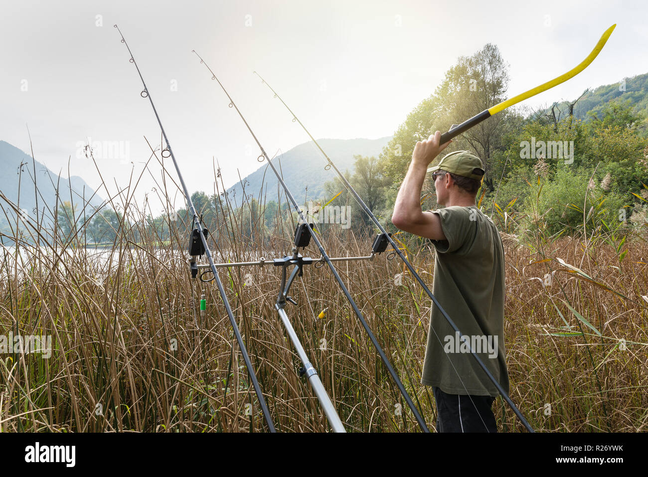 Fishing adventures. Angler with a throwing stick for boilies Stock Photo