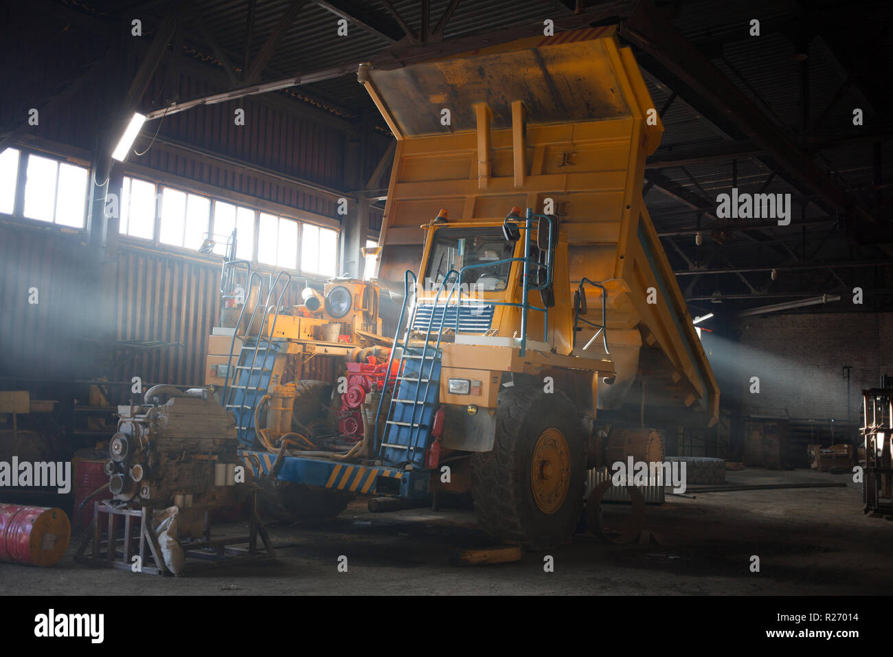 Yellow quarry dump truck in service zone Stock Photo