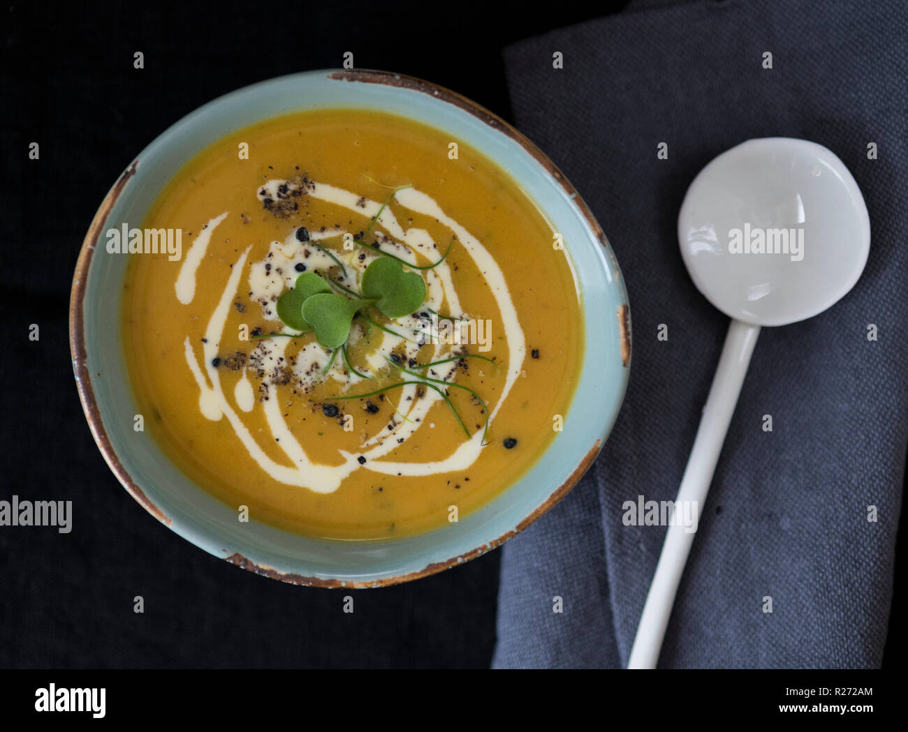 Carrot and coriander soup with black garlic Stock Photo Alamy