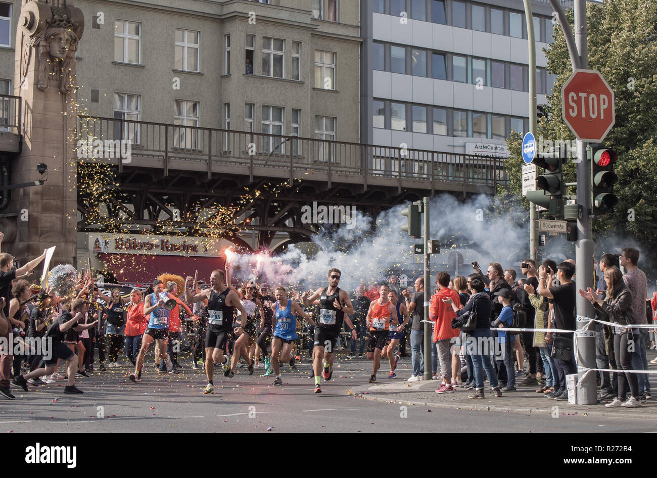 BERLIN, GERMANY - SEPTEMBER 25, 2016: Spectator With A Torch And Runners At Berlin Marathon 2016 Stock Photo