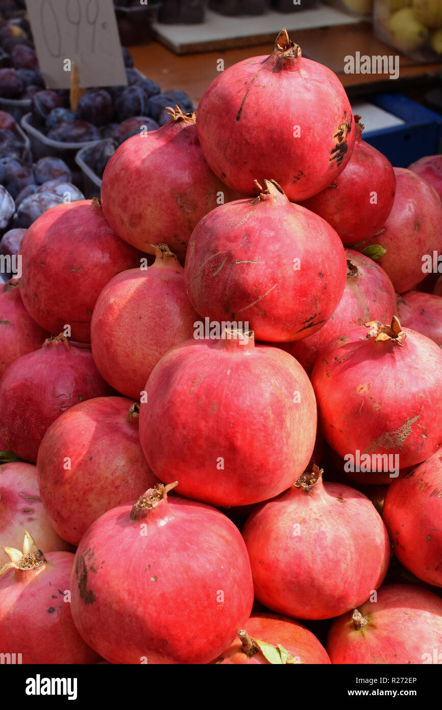 Fresh pomegranate fruit for sale at grocery store. Stock Photo