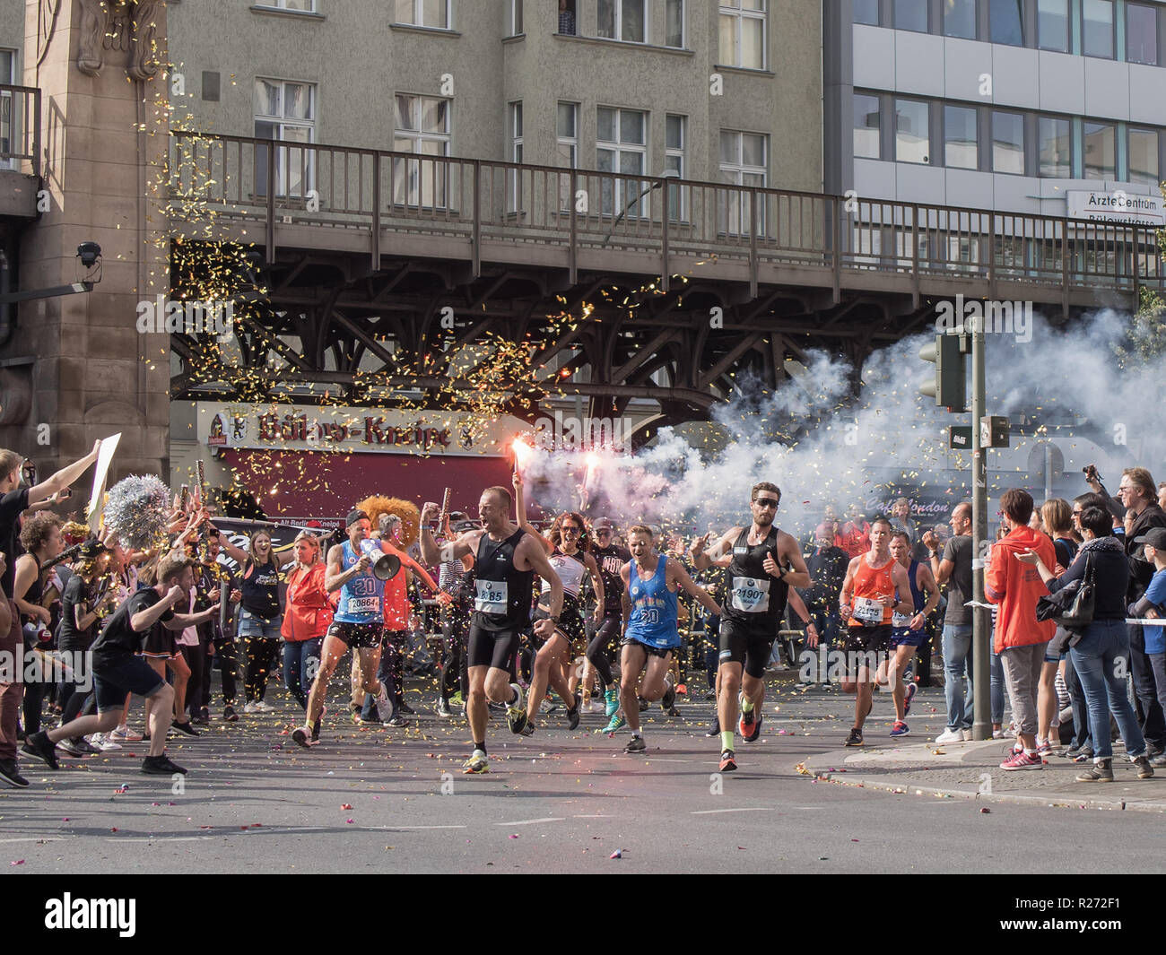 BERLIN, GERMANY - SEPTEMBER 25, 2016: Spectator With A Torch And Runners At Berlin Marathon 2016 Stock Photo