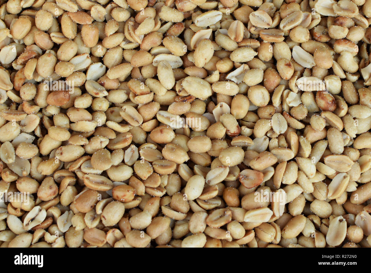 Salted roasted peeled peanuts snack food background. Stock Photo