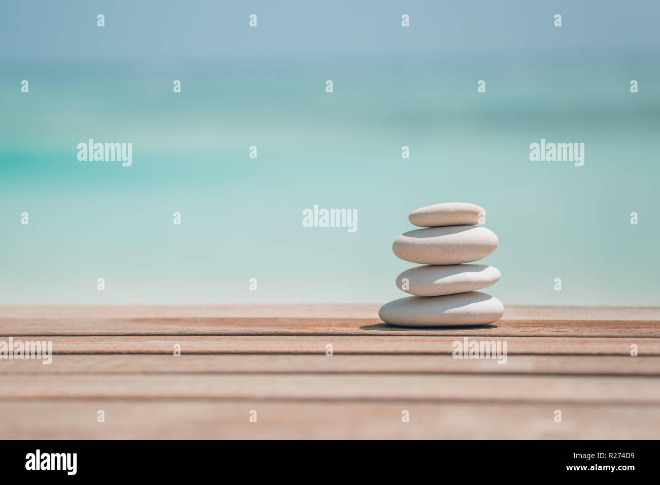 Zen stones on tropical beach for perfect meditation. Stones on soft sandy beach symbolizing stability, zen, relaxation, harmony, balance, inspiration Stock Photo